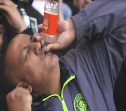 阿森納就這水瓶曼城球迷手握阿森納隊徽瓶子“對瓶吹”